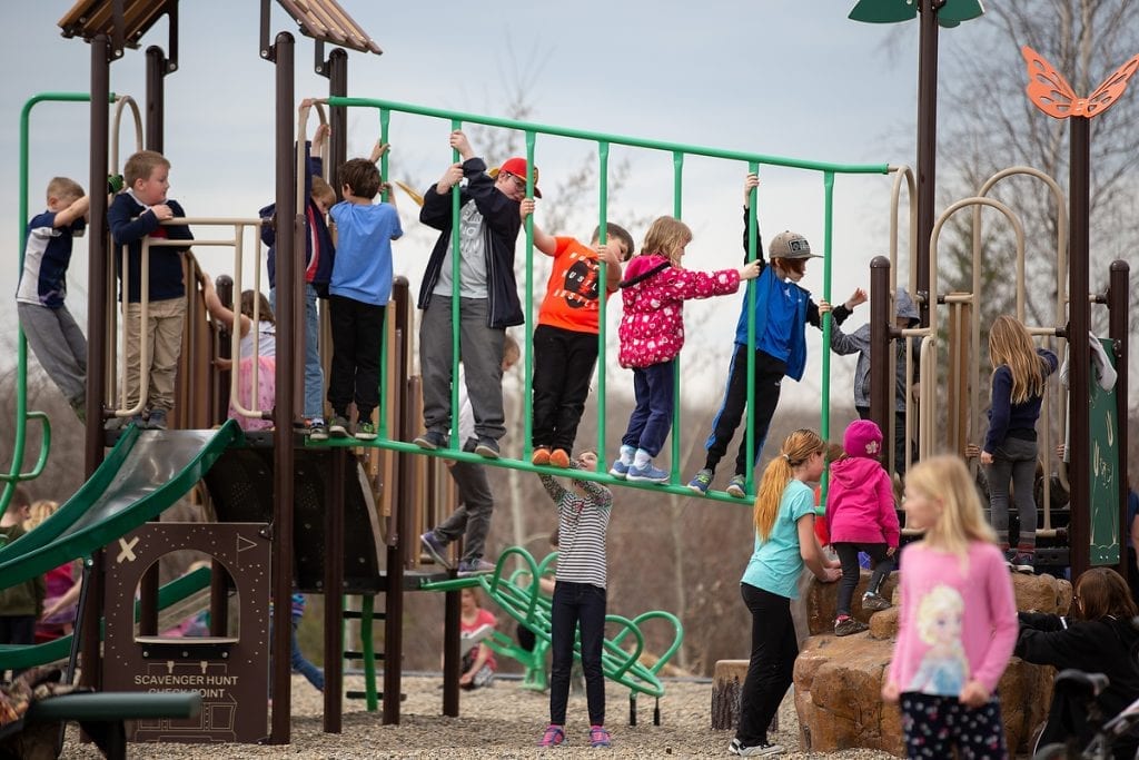 Children play on a playground at recess.