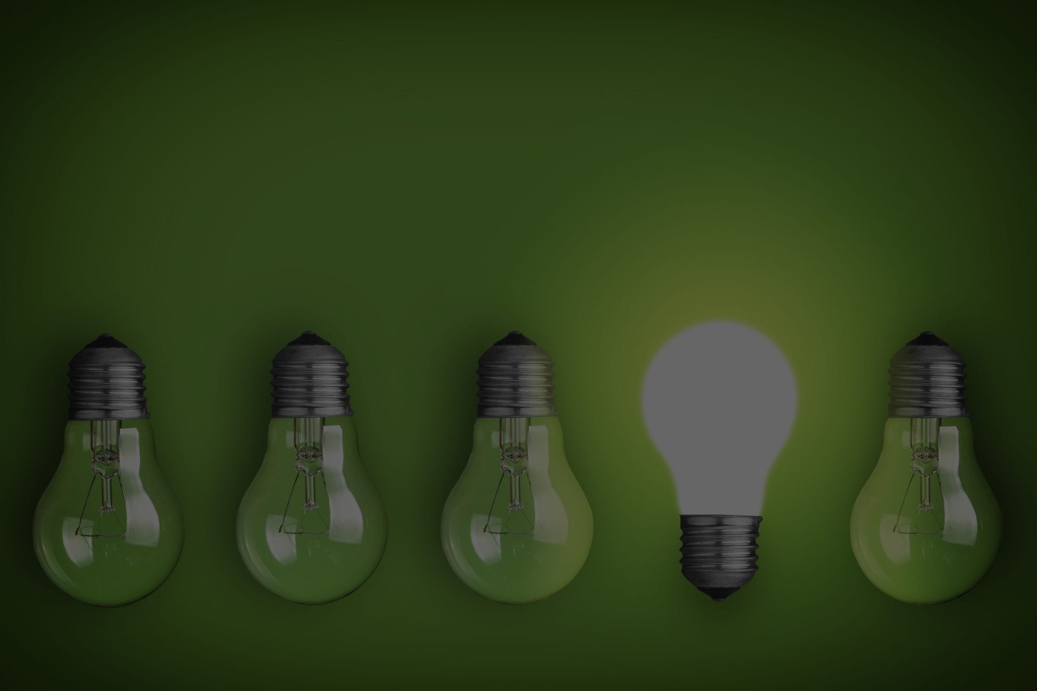 Idea concept with row of light bulbs and glowing bulb