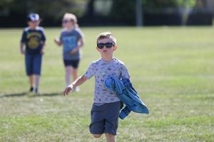 A student wearing sunglasses participates in the AMA Youth Run Club.