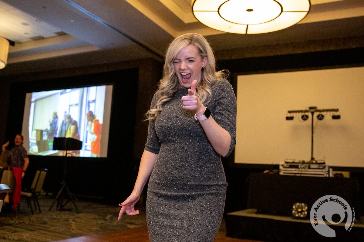 Erynn Biggar (Ever Active Schools) shows off her finger guns in a dance move at Shaping the Future 2022.