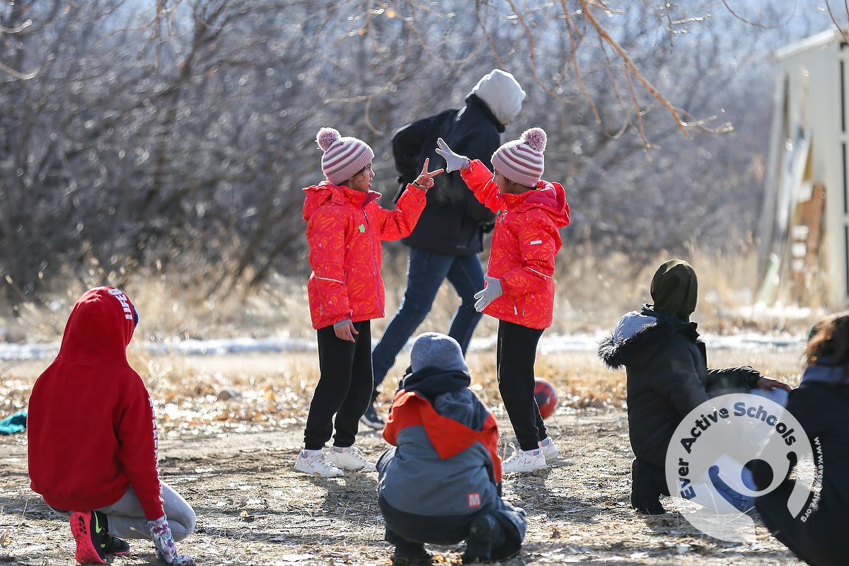 A group of new Canadian children and youth play Rock, Paper, Scissors games at Police Point Park in Medicine Hat, Alta.