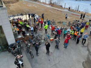 an overhead shot of winter cyclists stopping to enjoy coffee.