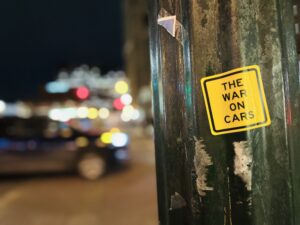 War on Cars podcast sticker on a lamppost
