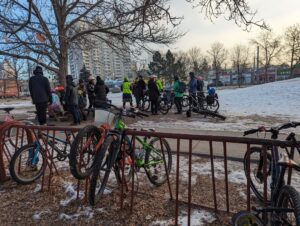 people gathering in a park to enjoy winter cycling