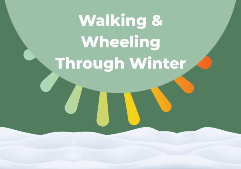 "Walking & Wheeling Through Winter" in a green semi-circle with a snowbank covering the bottom third